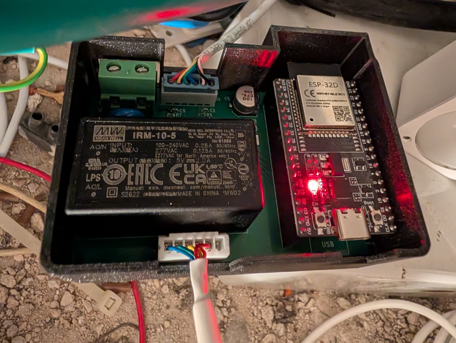 Breezy installed in the attic, lid off: mains supply, ESP32, both cables