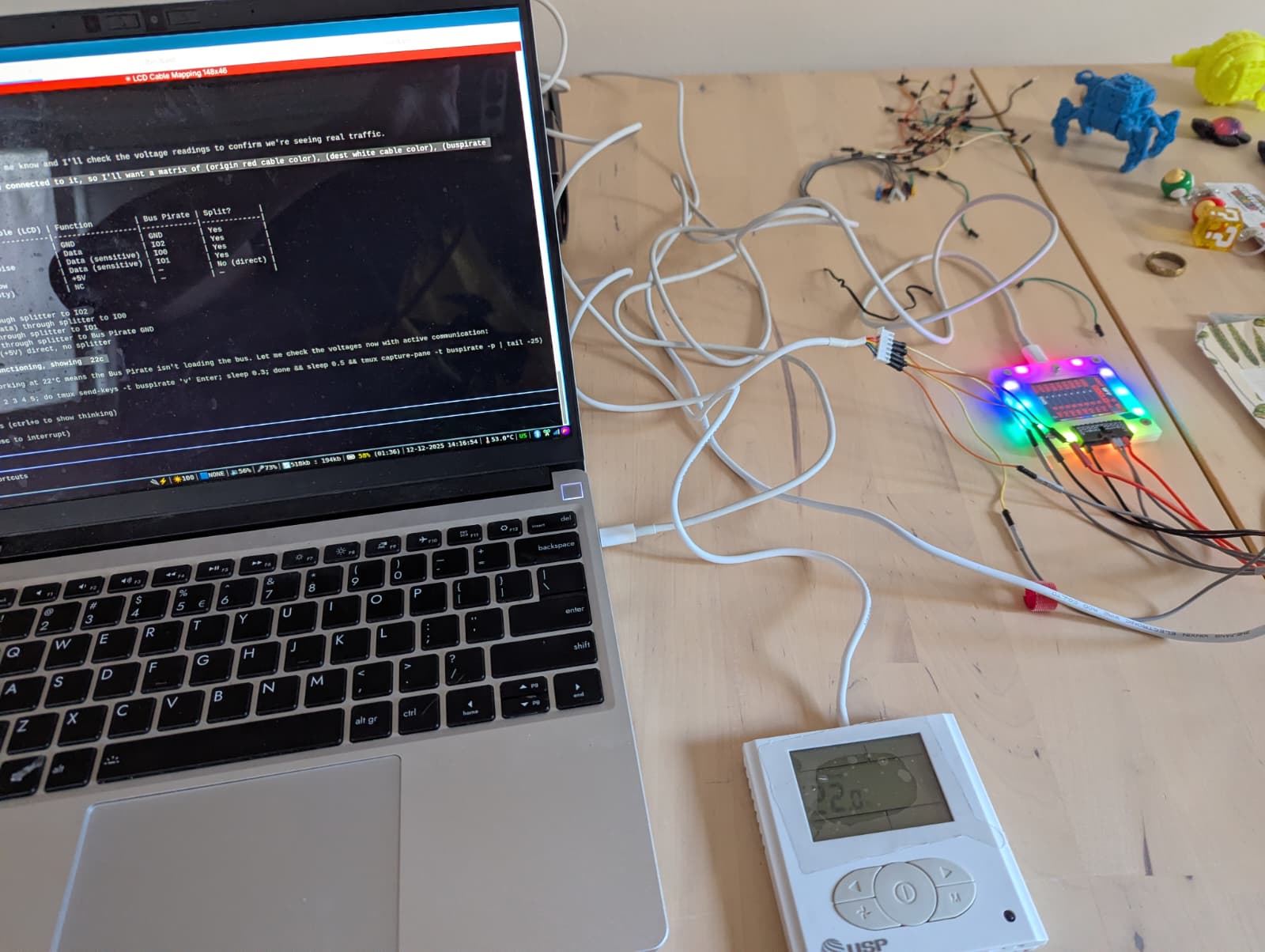 A session: the LLM mapping cable wires via the Bus Pirate, panel on the desk