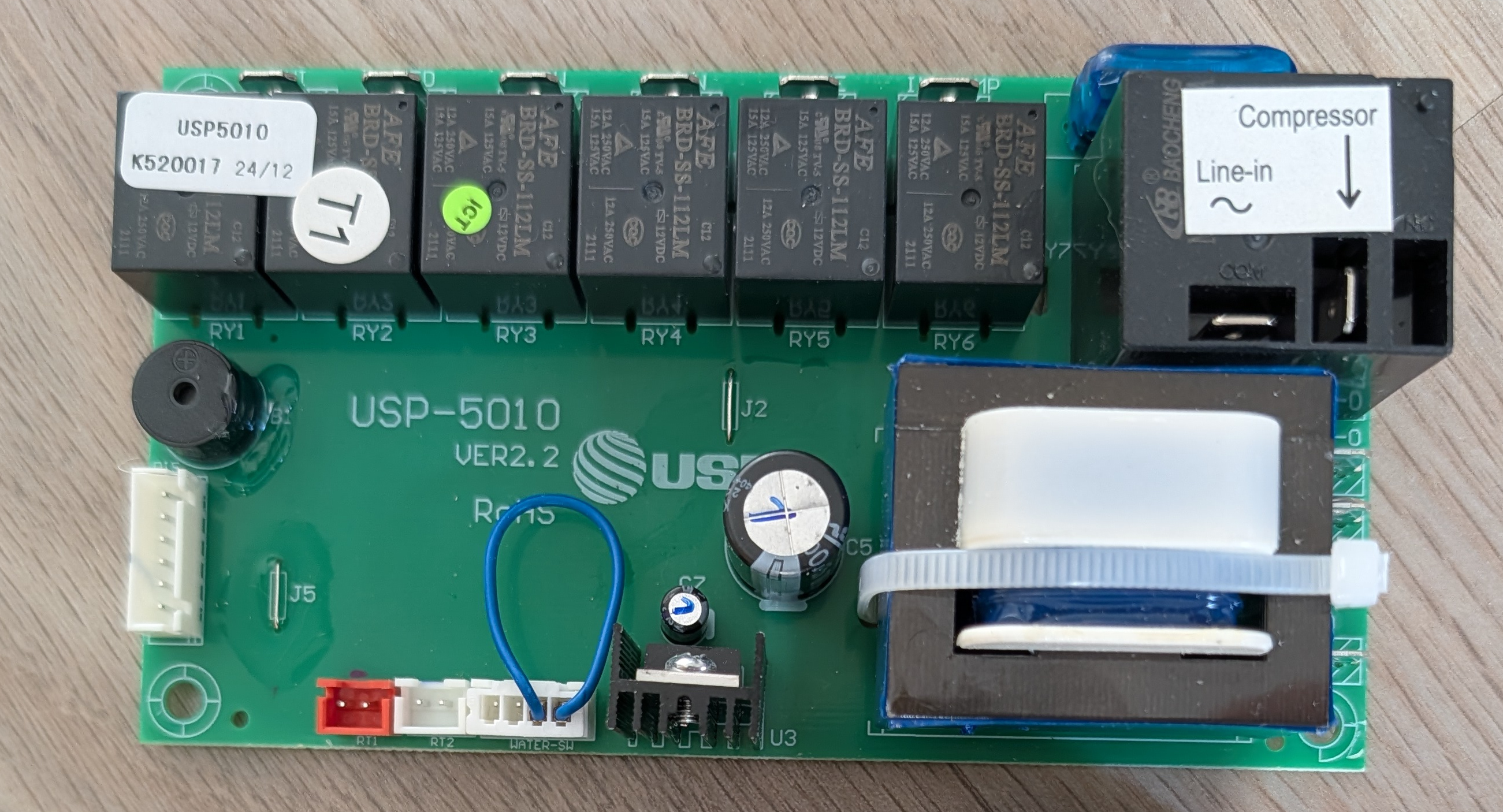 The spare USP-5010 controller board: six relays, a compressor contactor, a transformer, and one small white JST connector